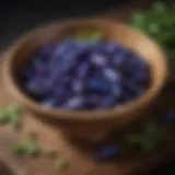 Vibrant blue butterfly pea pods in a wooden bowl