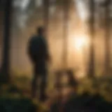 Silhouetted forest ranger with rescue dog at sunset